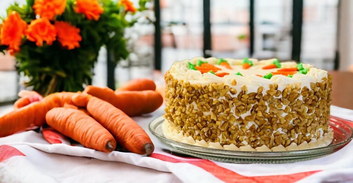 Carrots on a table next to a carrot cake at Wild Flour Bakery